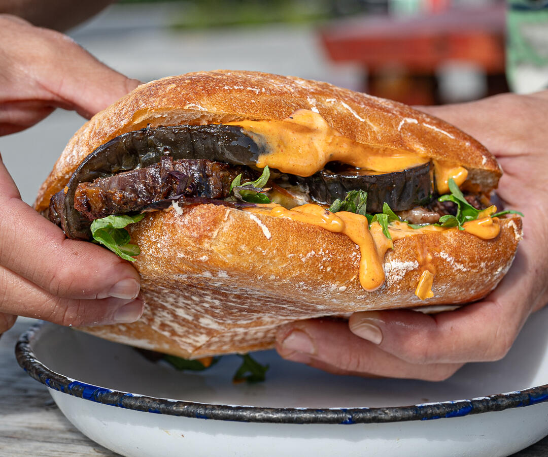 someone holding a sandwich in wanaka